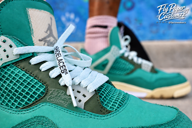 Close-up detail of mint green custom Off-White-inspired Jordan 4 sneakers